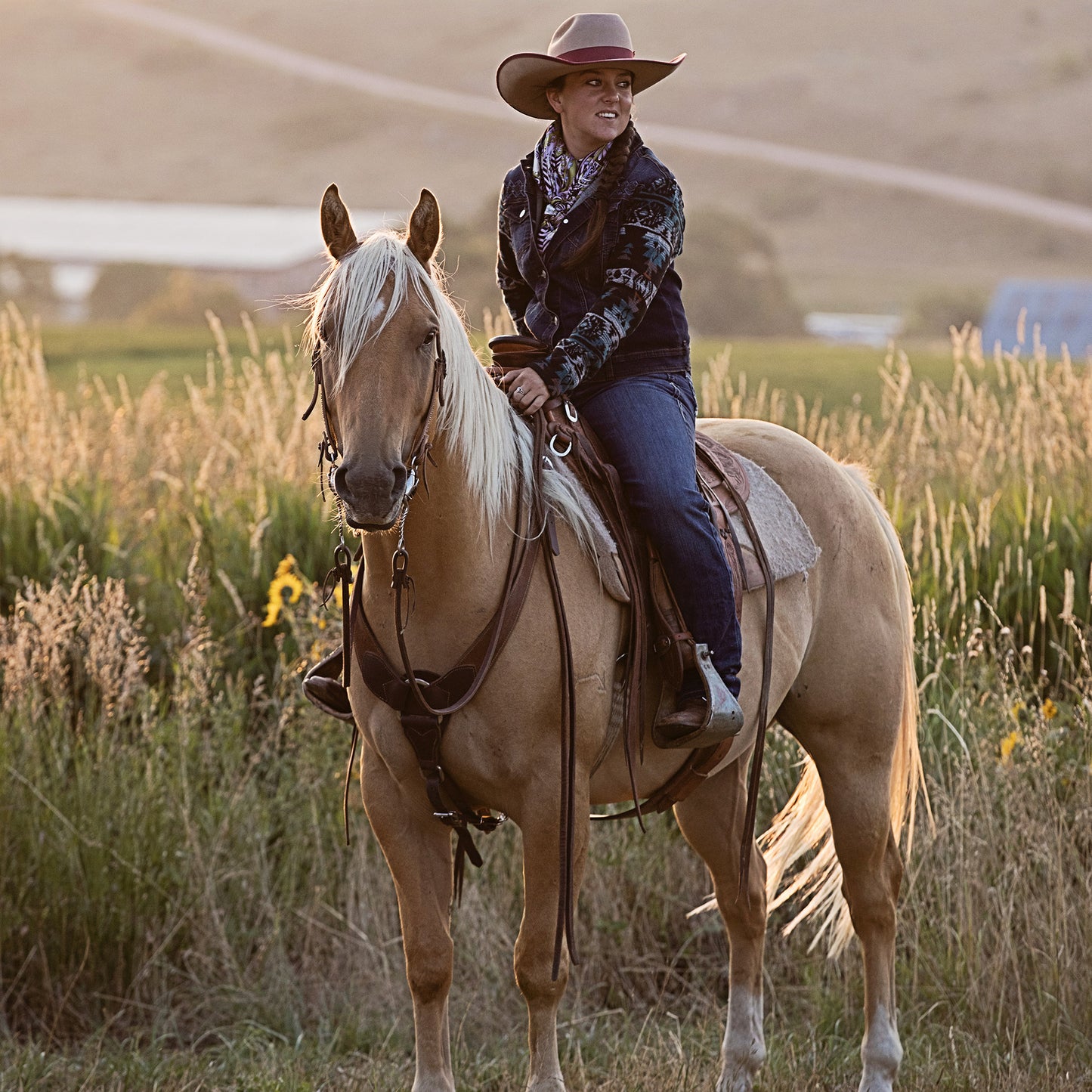 Cowgirl riding Palomino Horse